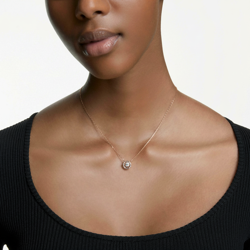 Swarovski Una necklace with round-cut white crystal pendant in rose gold-tone plated setting, elegant jewelry accessory.