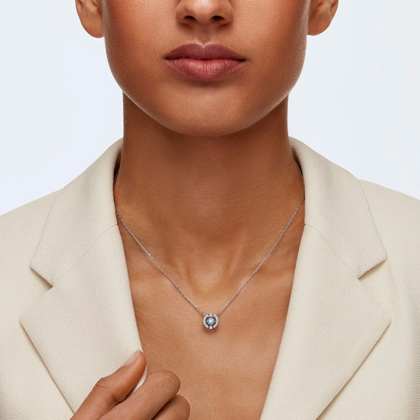 Swarovski Una necklace featuring a round cut blue crystal pendant on rhodium-plated chain, elegant jewelry accessory.