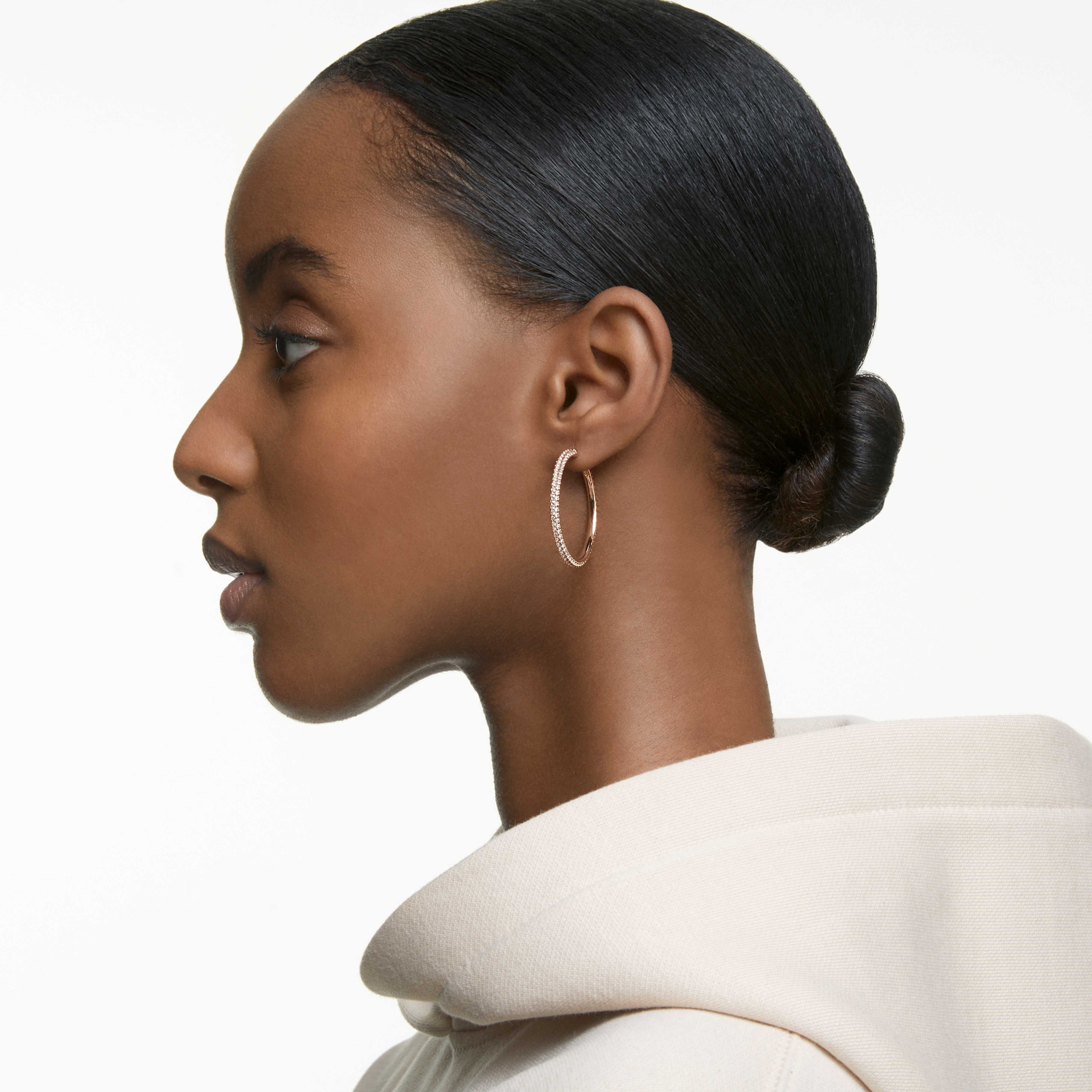 Large Swarovski Dextera hoop earrings with pavé white stones, rose gold-tone plated, showcasing elegant, sparkling jewelry.