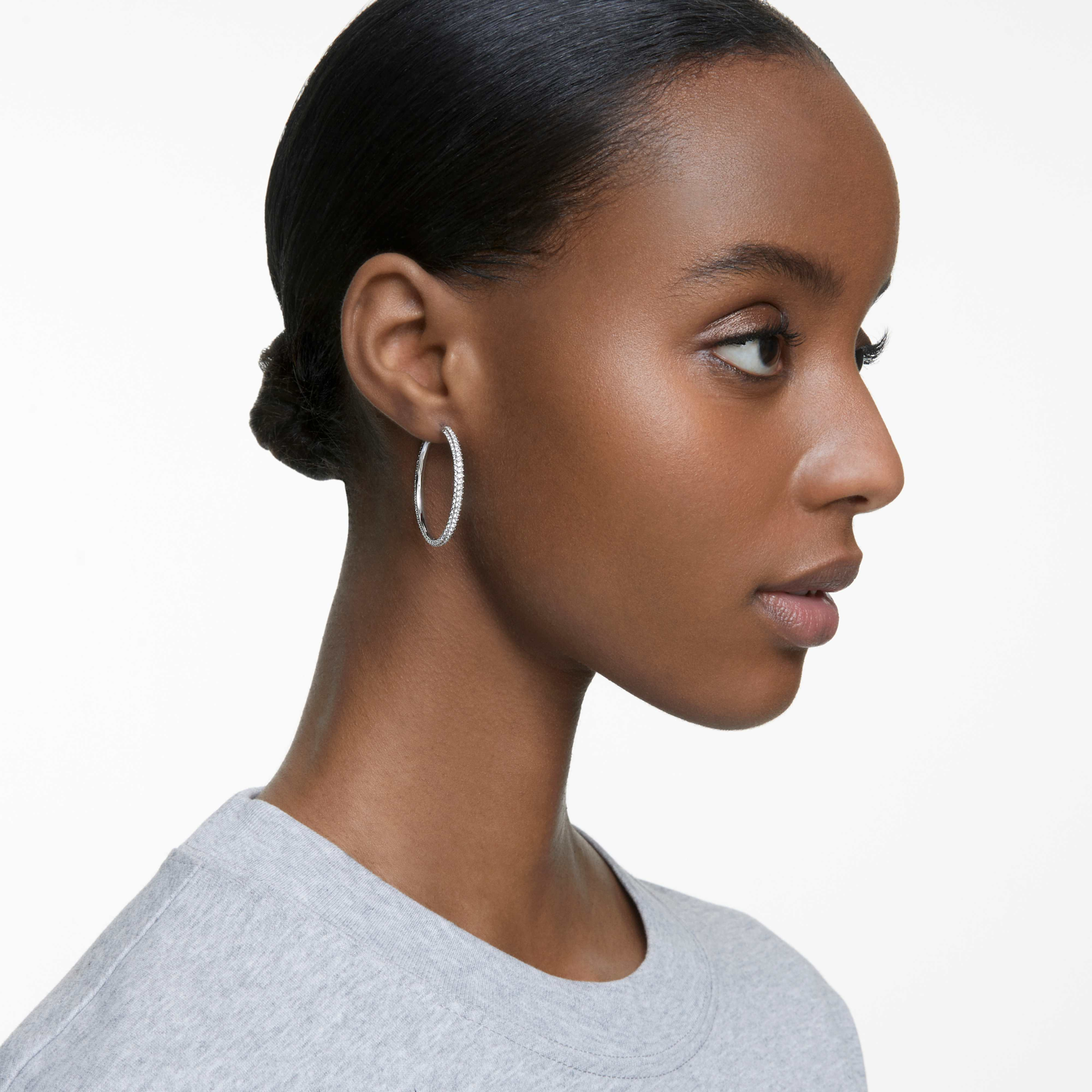 Large Swarovski Dextera hoop earrings with pavé white crystals and rhodium plating, showcasing elegant, sparkling jewelry design.