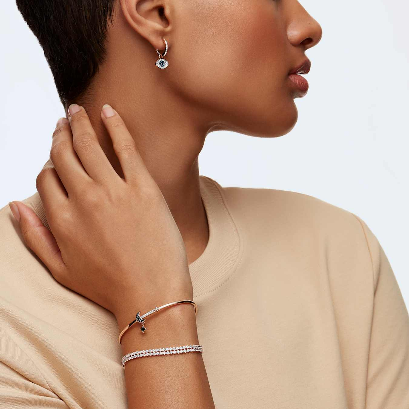 Swarovski Symbolic Evil Eye Hoop Earrings featuring sparkling crystal accents and hoop design for pierced ears.