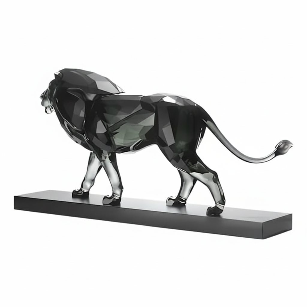 Swarovski The Lion crystal figurine with detailed gold accents, showcasing a majestic lion in a sitting pose.
