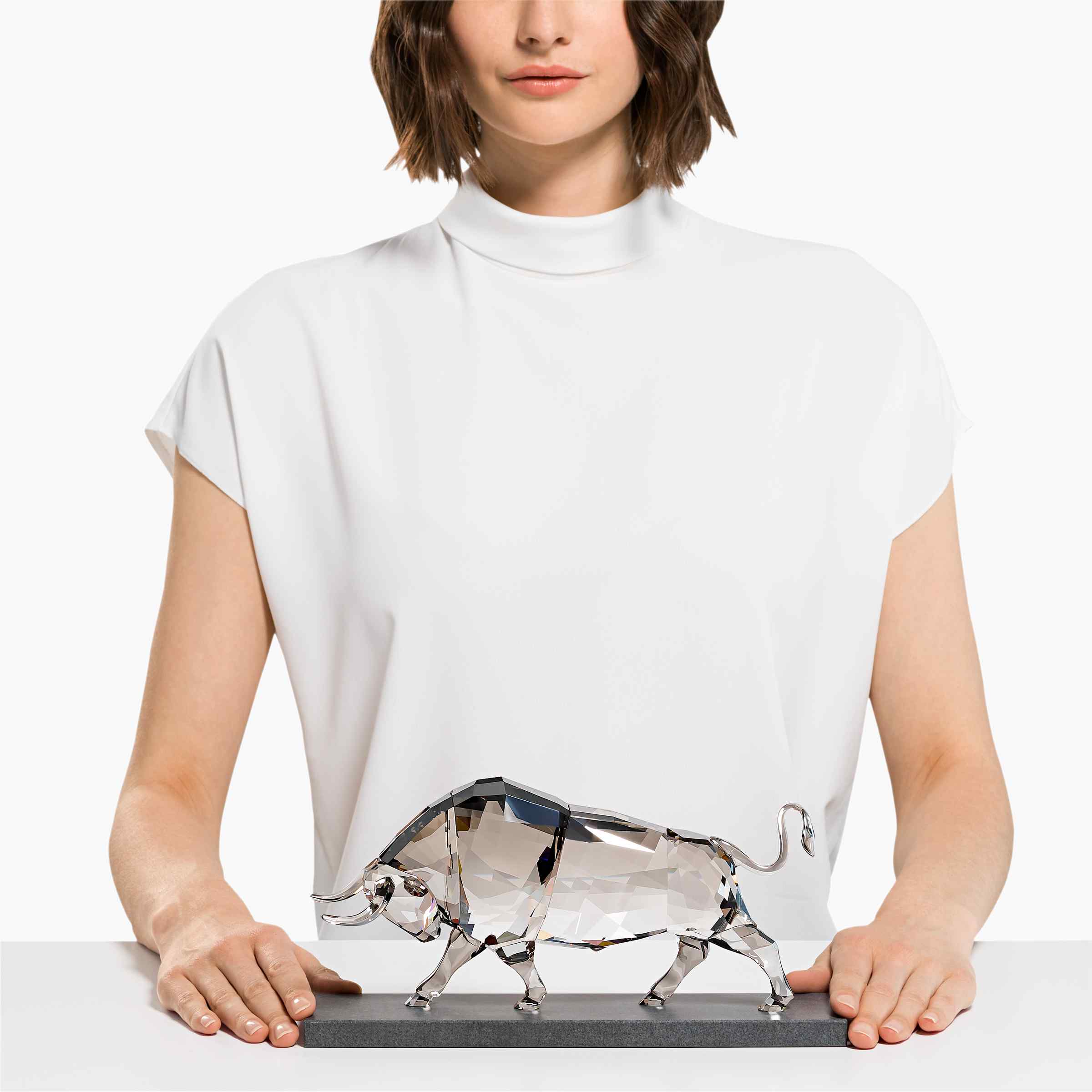 Swarovski Soulmates Bull figure made of clear crystal, detailed with intricate facets and craftsmanship.