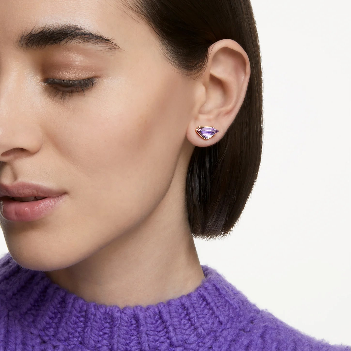 Swarovski Lucent single ear cuff with purple gemstone, gold-tone plating and magnetic closure, stylish and elegant jewelry accessory.