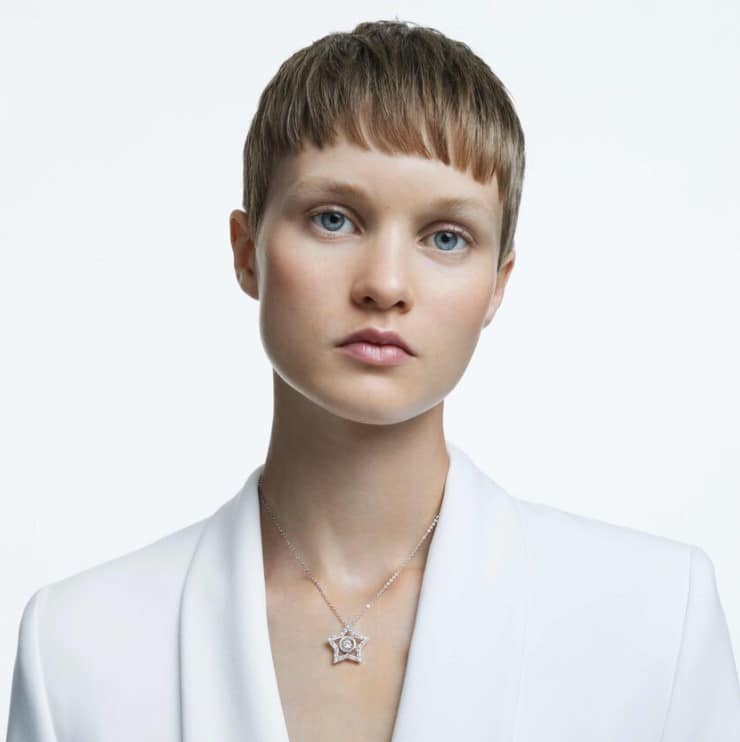 Swarovski Stella Pendant with mixed cut white crystals, star shape, rhodium plated, hanging from a delicate chain.