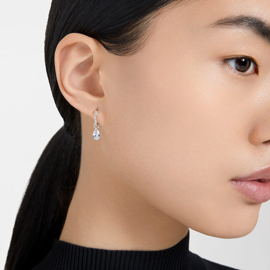 Swarovski Millenia hoop earrings with pear-shaped white crystals and rhodium plating, showcasing elegant jewelry design.