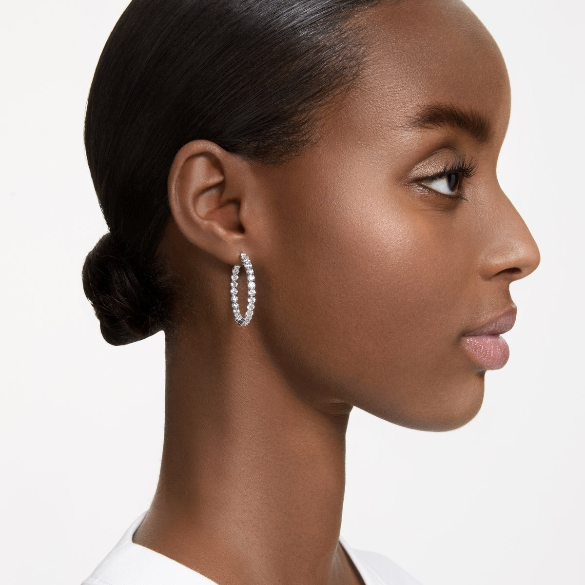 Swarovski Matrix hoop earrings with round white crystals and rhodium plating, showcasing elegant jewelry design.