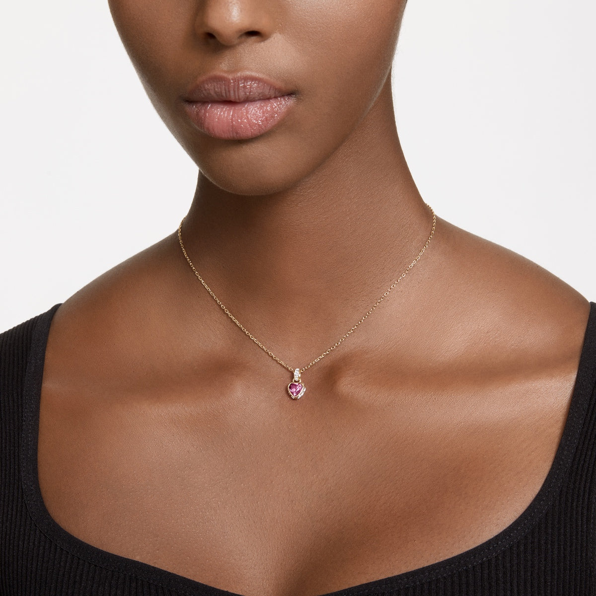 Swarovski Chroma pendant in heart shape with red crystals and gold-tone plated setting, showcasing elegant jewelry design.