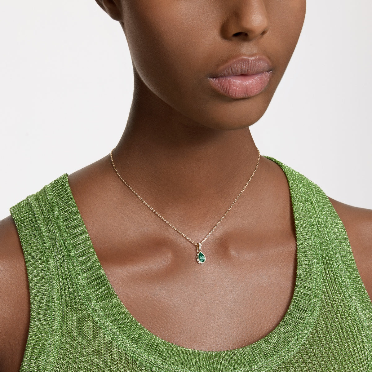 Swarovski Chroma green pear-cut pendant with gold-tone plating, showcasing a sparkling gemstone on a delicate chain.