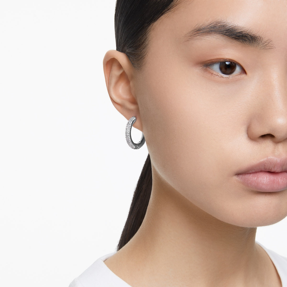Swarovski Dextera medium hoop earrings in white with rhodium plating, featuring a sleek and elegant design.
