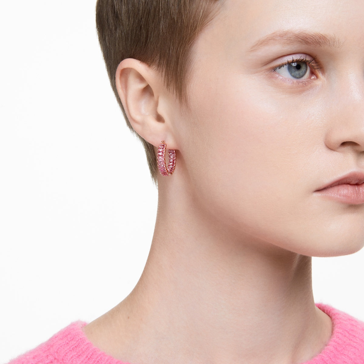 Swarovski Matrix hoop earrings with pink baguette-cut crystals in rose gold-tone plating, featuring a sleek, modern design.