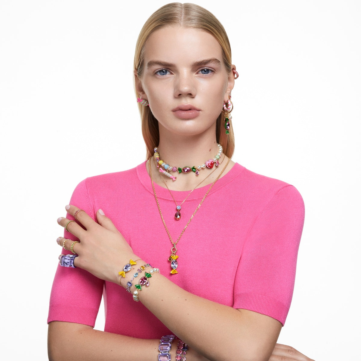 Swarovski Matrix hoop earrings with pink baguette-cut crystals in rose gold-tone plating, showcasing elegant and sparkling jewelry design.