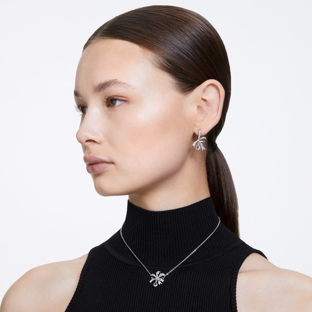 Swarovski Volta bow earring and necklace set with white and rhodium plating, featuring sparkling crystal accents.