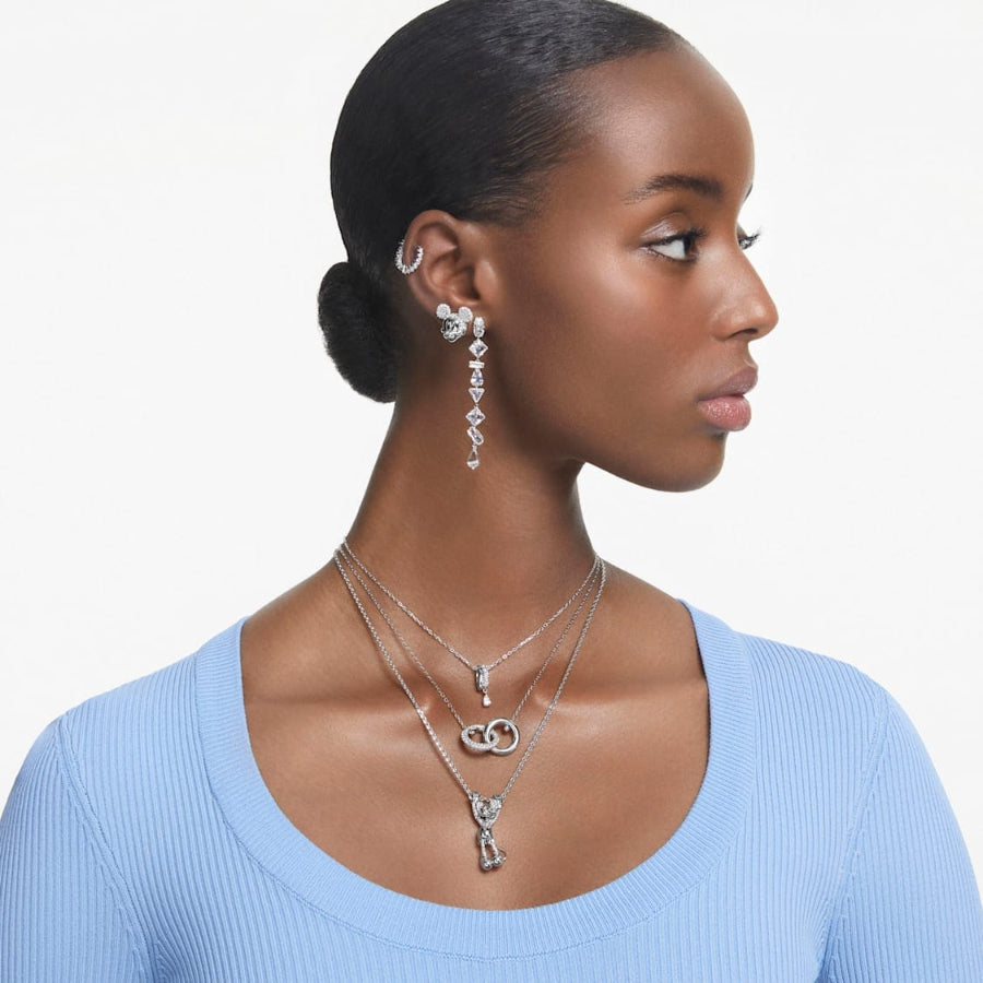 Swarovski Mesmera drop earrings with asymmetrical design, mixed cuts, long white rhinestones, and rhodium plating.