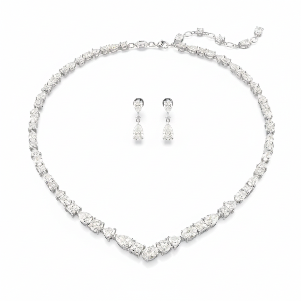 Swarovski Mesmera jewelry set with mixed cut white crystals in rhodium-plated finish, featuring earrings and necklace.