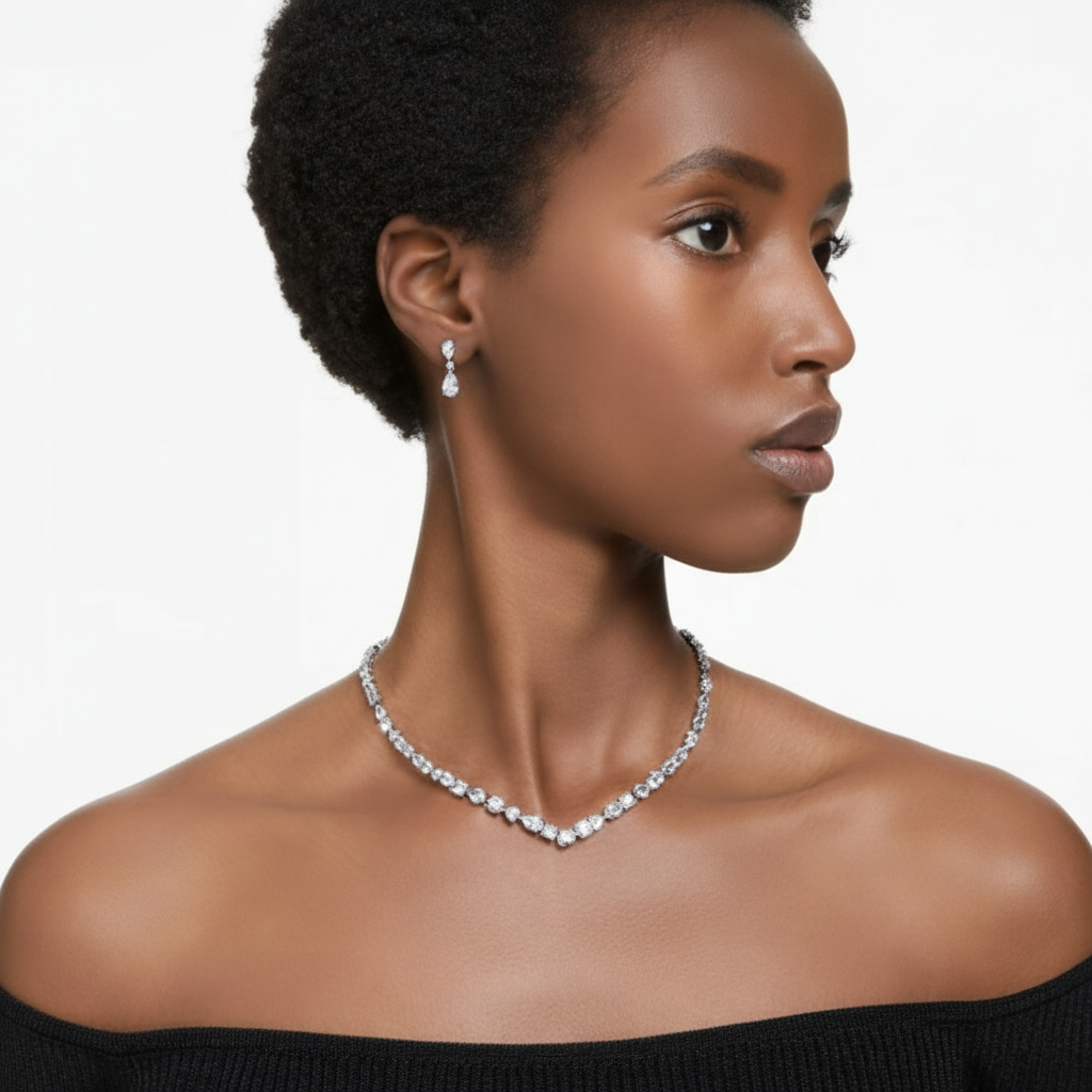 Swarovski Mesmera jewelry set with mixed cut white crystals, rhodium plated, featuring earrings and necklace on a display card.