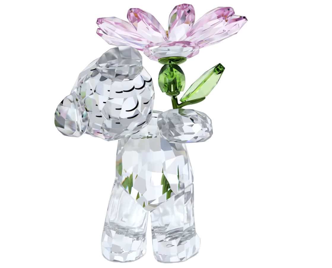 Swarovski Kris Bear holding a daisy, detailed crystal figurine with sparkling accents, part of the Swarovski Kris Bear collection.
