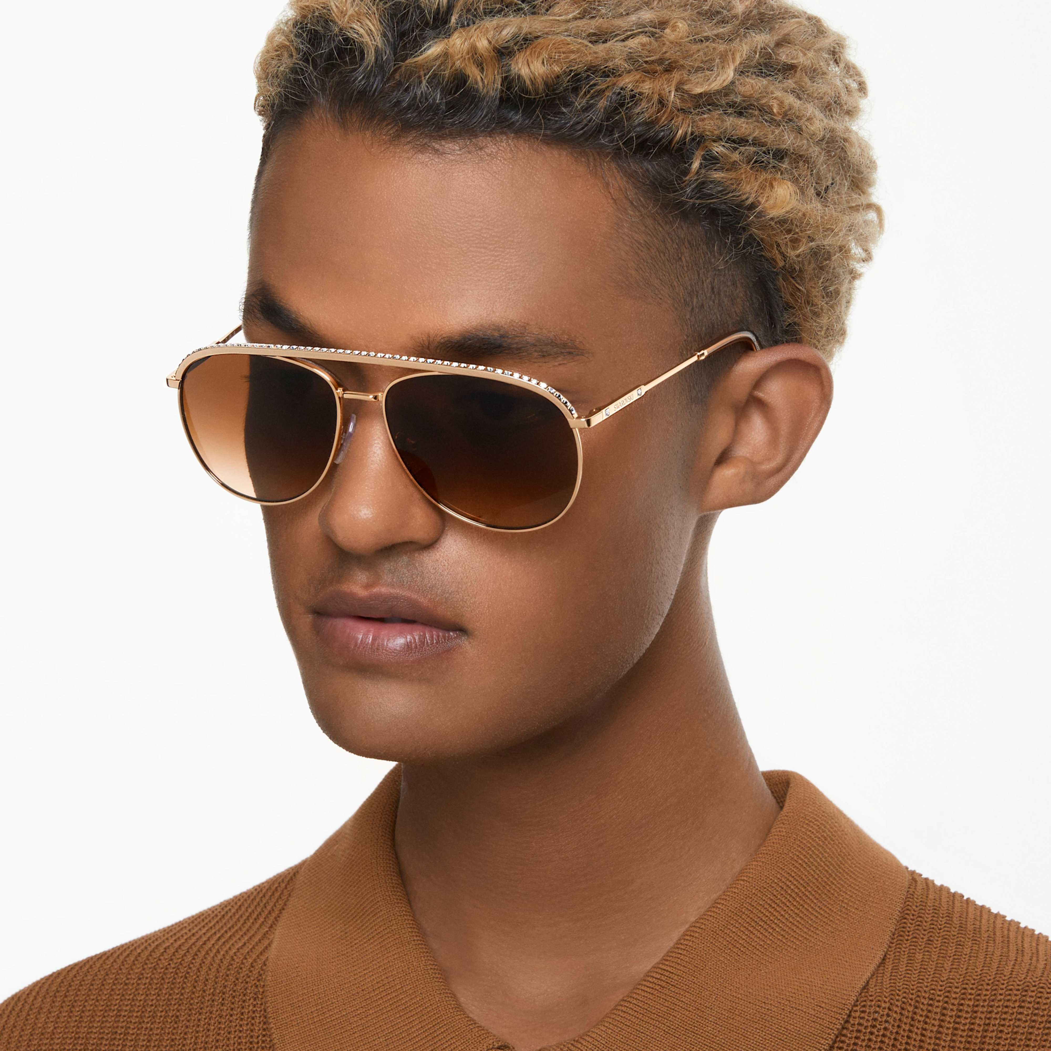 Swarovski Orbita SK7005EL sunglasses with brown frames and tinted lenses, stylish accessory with Swarovski branding.