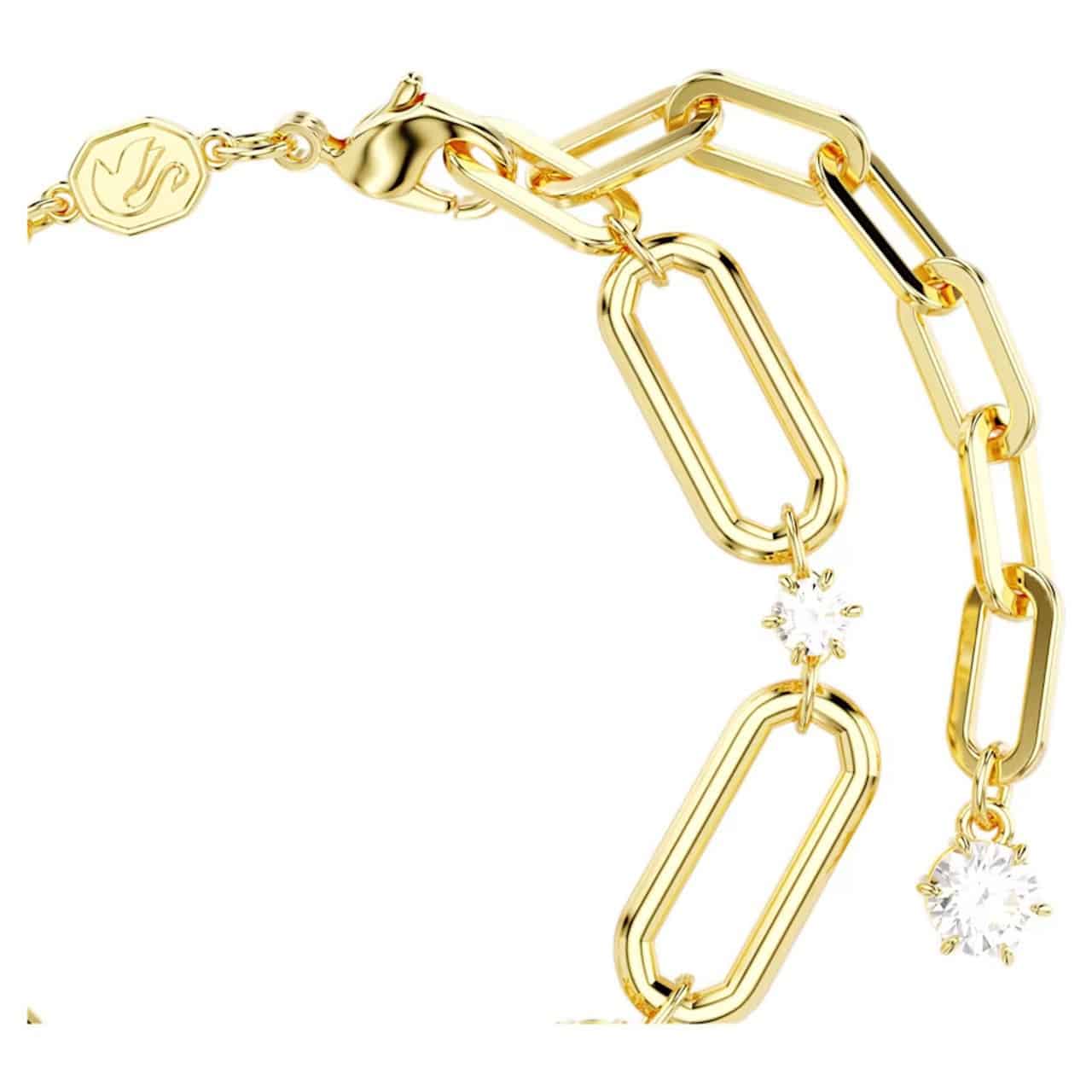 Swarovski Constella bracelet with white stones and gold-tone plating, elegant jewelry accessory on a neutral background.