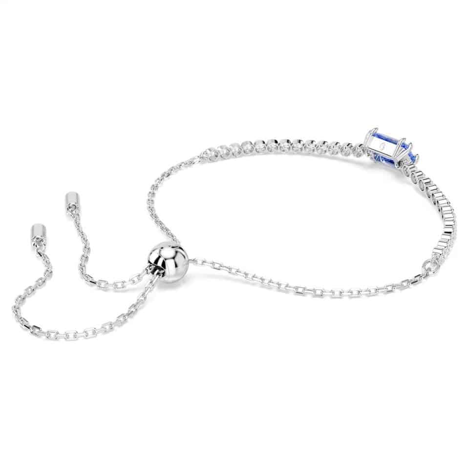 Swarovski Matrix Tennis Bracelet with mixed-cut blue crystals and rhodium plating, elegant jewelry accessory on a white background.