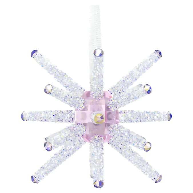 Swarovski Wicked Wand Ornament featuring a sparkling crystal wand with intricate detailing and a decorative stand.