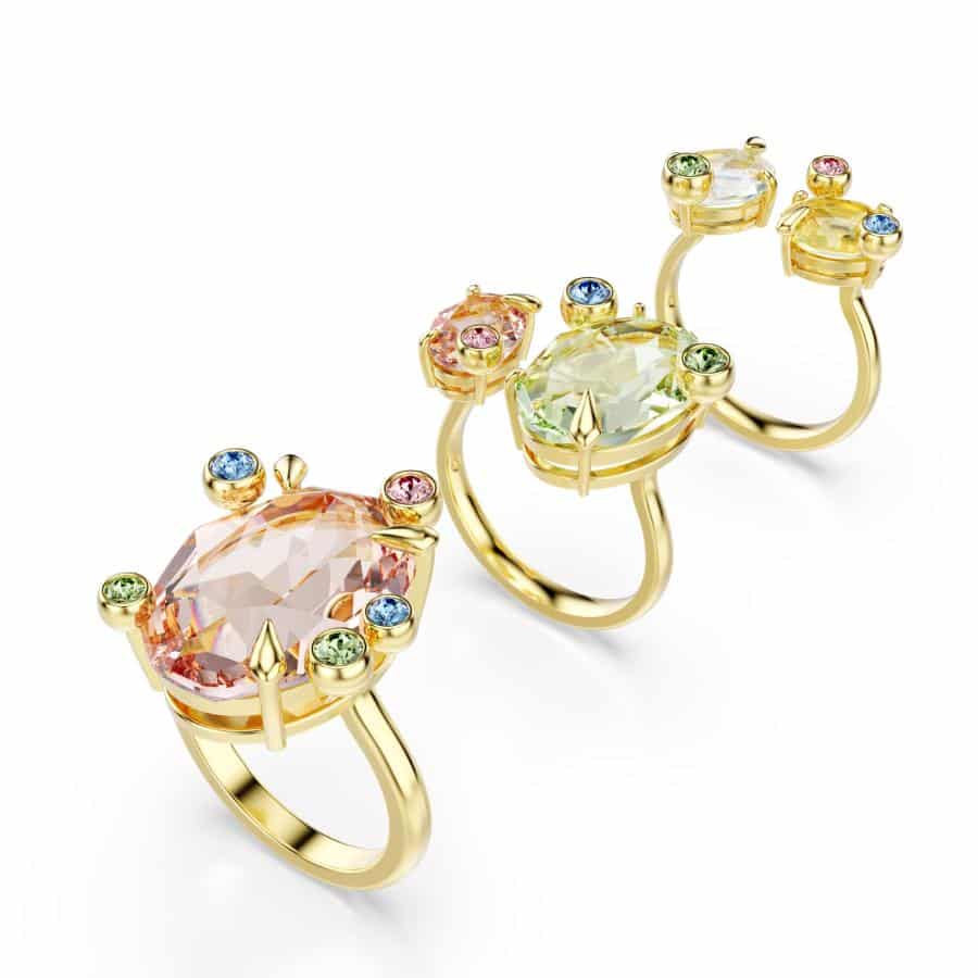 Swarovski Gema ring set with three multicolored, mixed-cut crystals in gold-tone plating, showcasing elegant jewelry design.