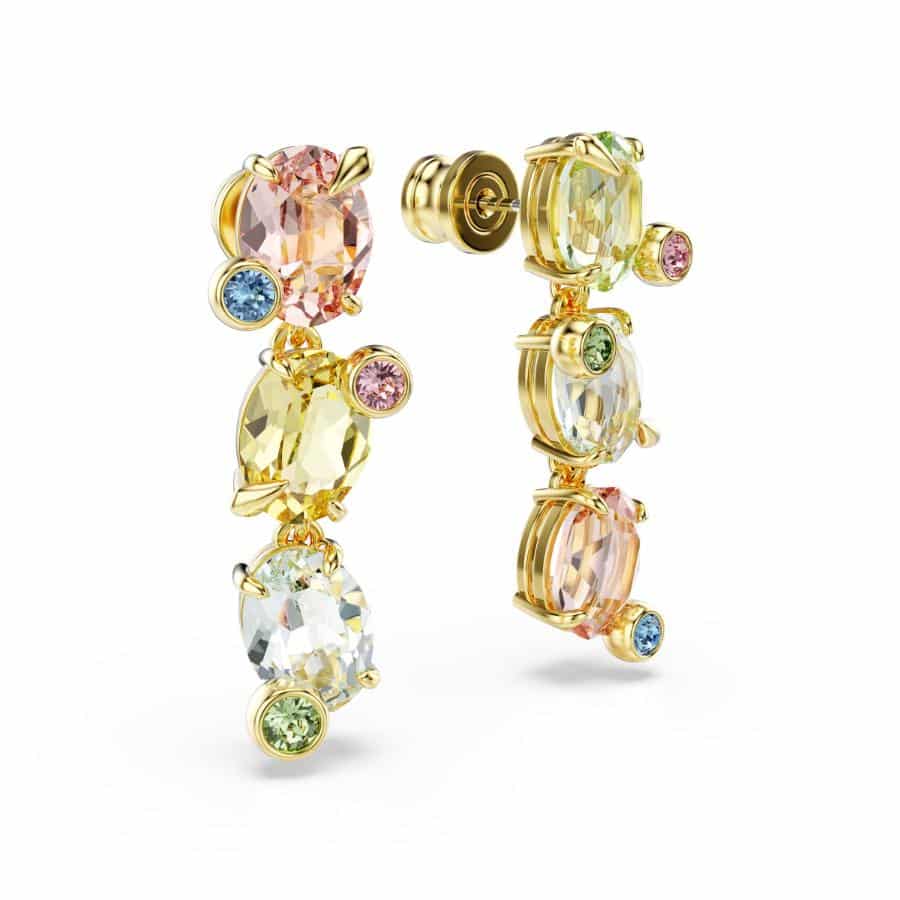 Swarovski Gema Drop Earrings with asymmetrical mixed-cut multicolored crystals and gold-tone plating on a white background.