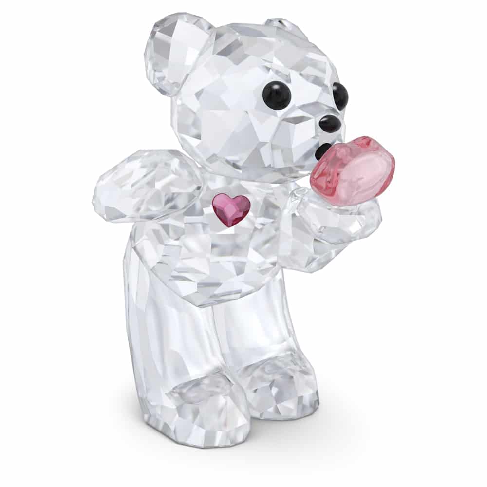 Swarovski Kris Bear figurine holding a heart-shaped kiss, detailed crystal craftsmanship, part of the Swarovski Kris Bear collection.