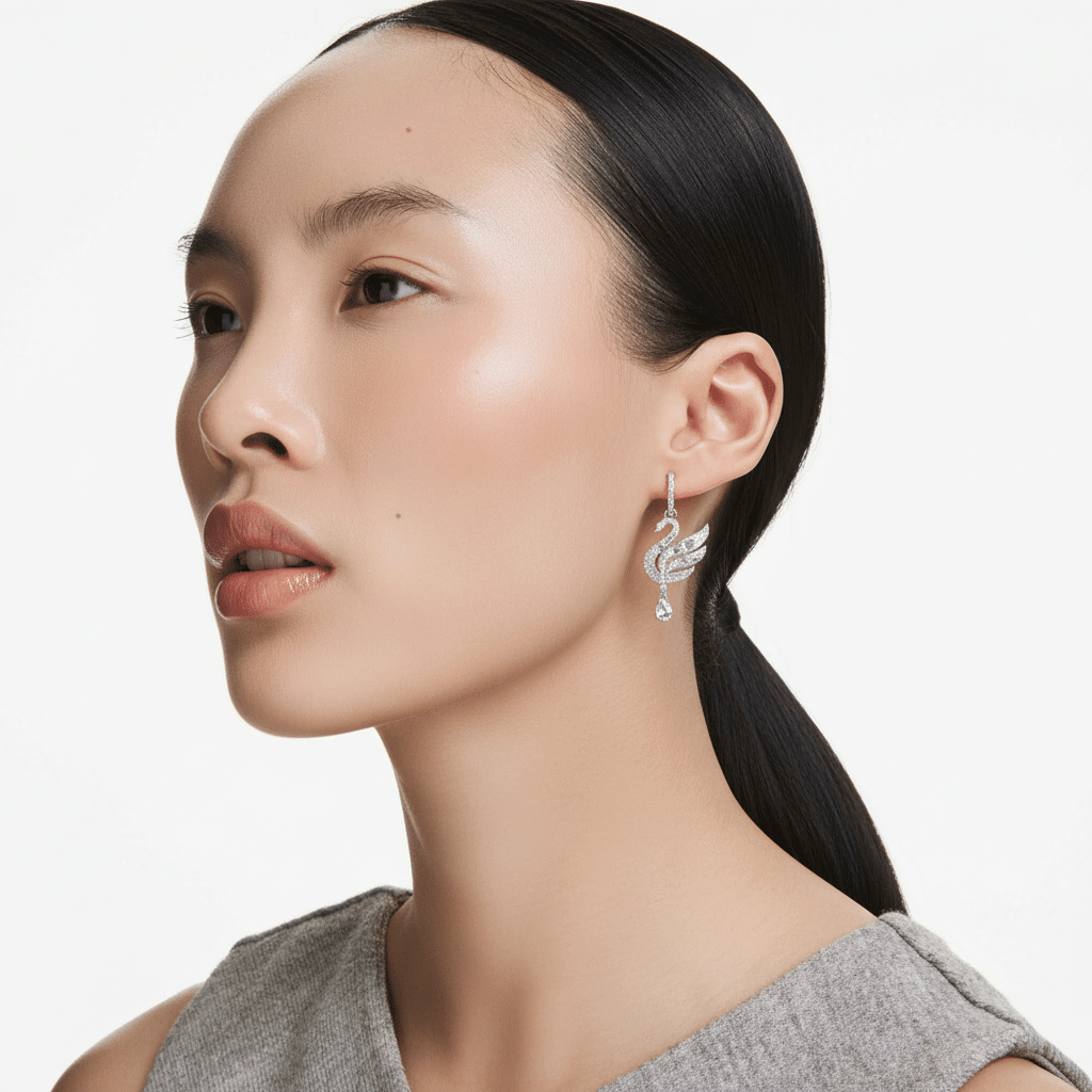 Swarovski Swan earrings in white with rhodium plating, featuring elegant swan-shaped jewelry with sparkling crystal details.
