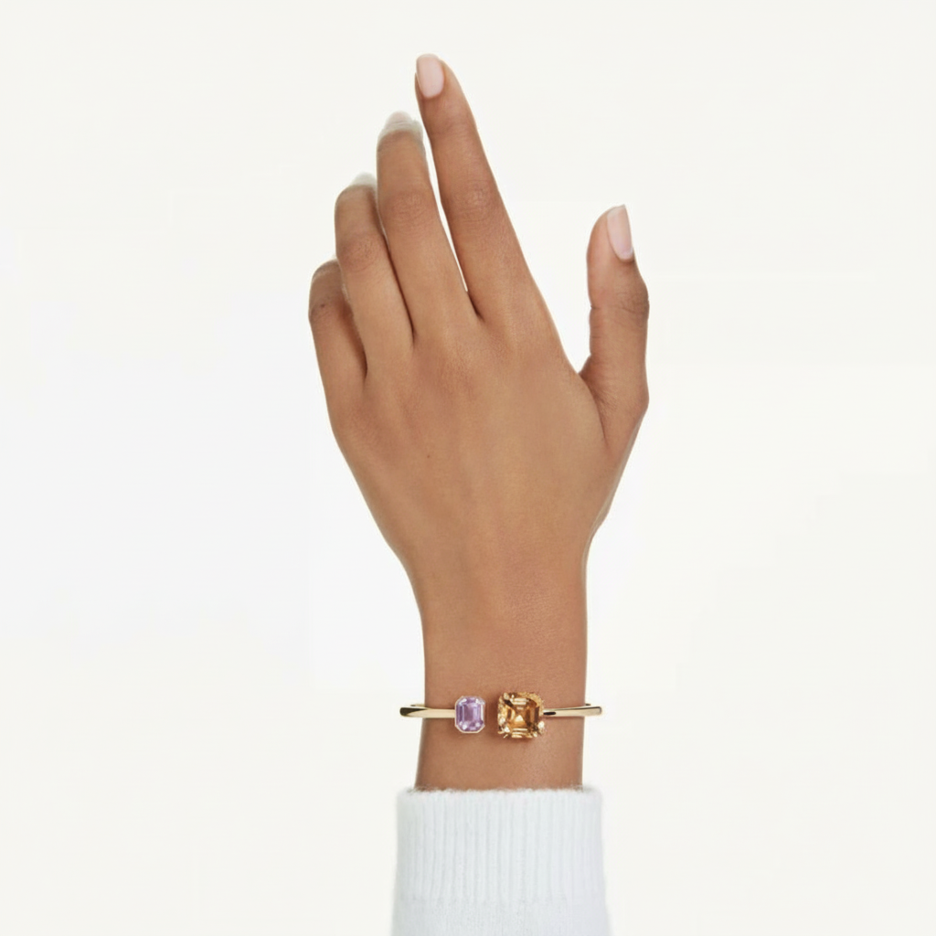 Swarovski Millenia bangle with multicolored octagon cut crystals and gold-tone plating, stylish jewelry accessory.