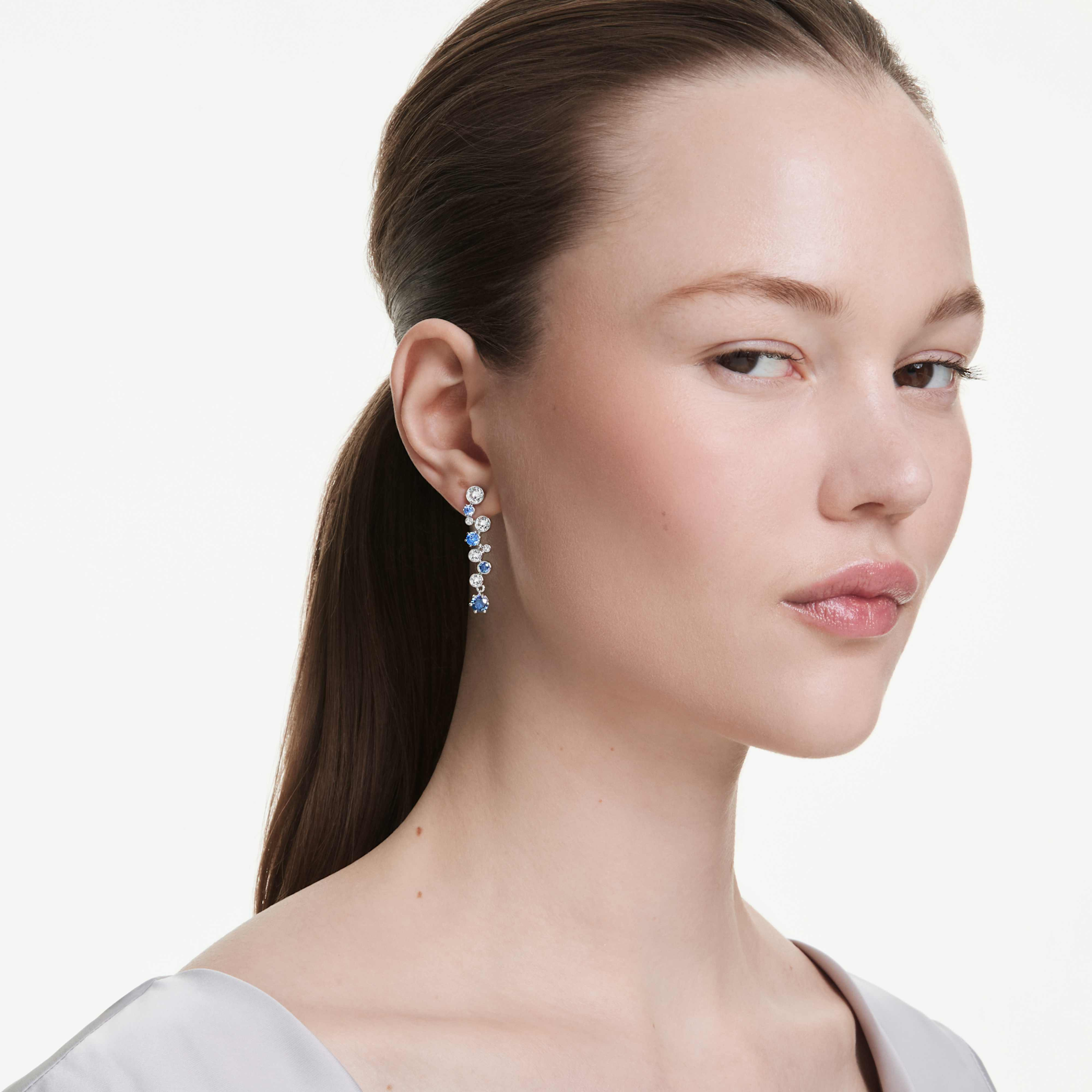 Swarovski Constella drop earrings with mixed blue crystal cuts and rhodium-plated setting, showcasing elegant jewelry design.