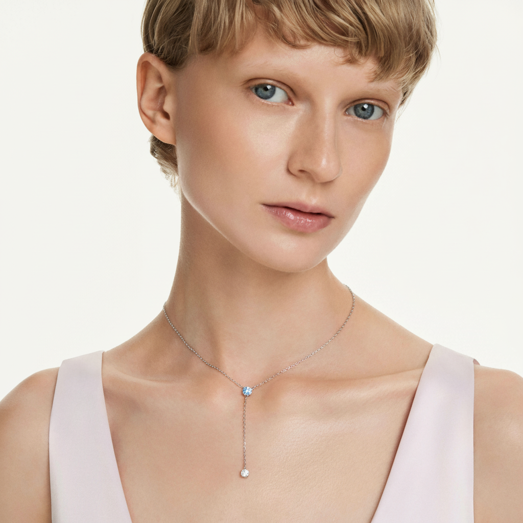 Swarovski Stilla necklace with blue crystal accents and rhodium-plated chain, elegant jewelry piece.