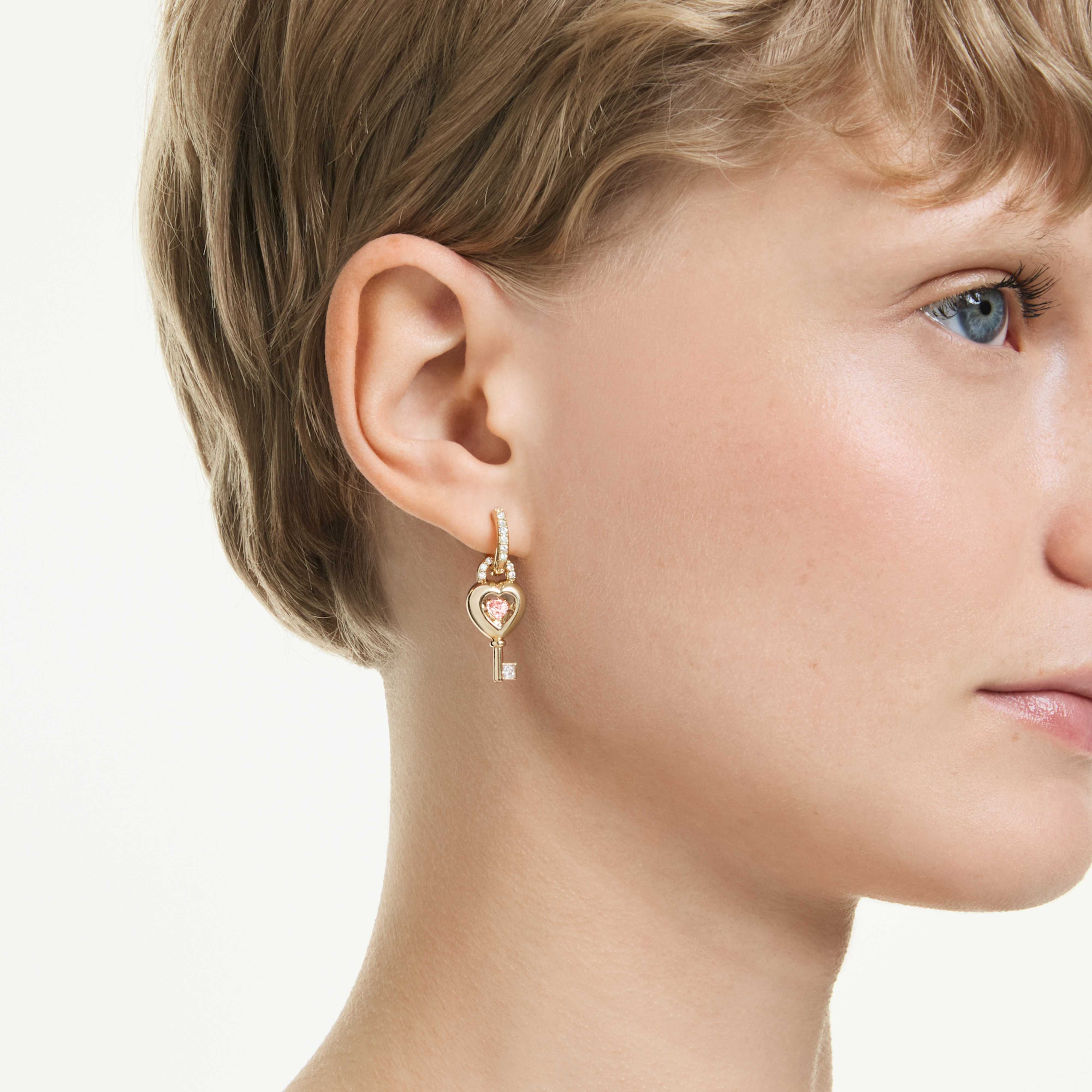 Swarovski Idyllia drop earrings with pink heart and key design, gold-tone plated, featuring mixed cuts and an ear cuff detail.