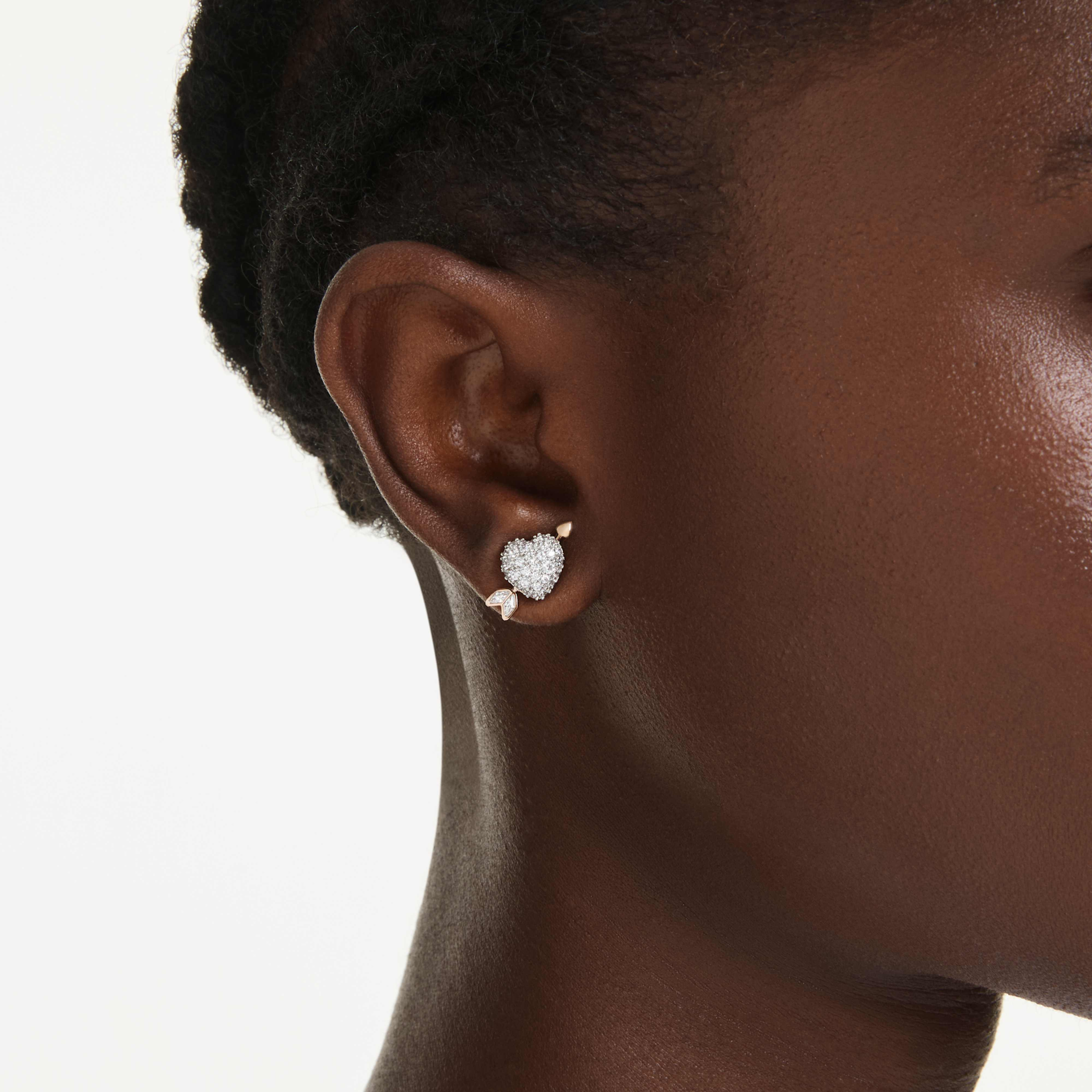 Swarovski Idyllia stud earrings featuring a white heart with arrow design and mixed metal finish, with faceted mixed cuts.