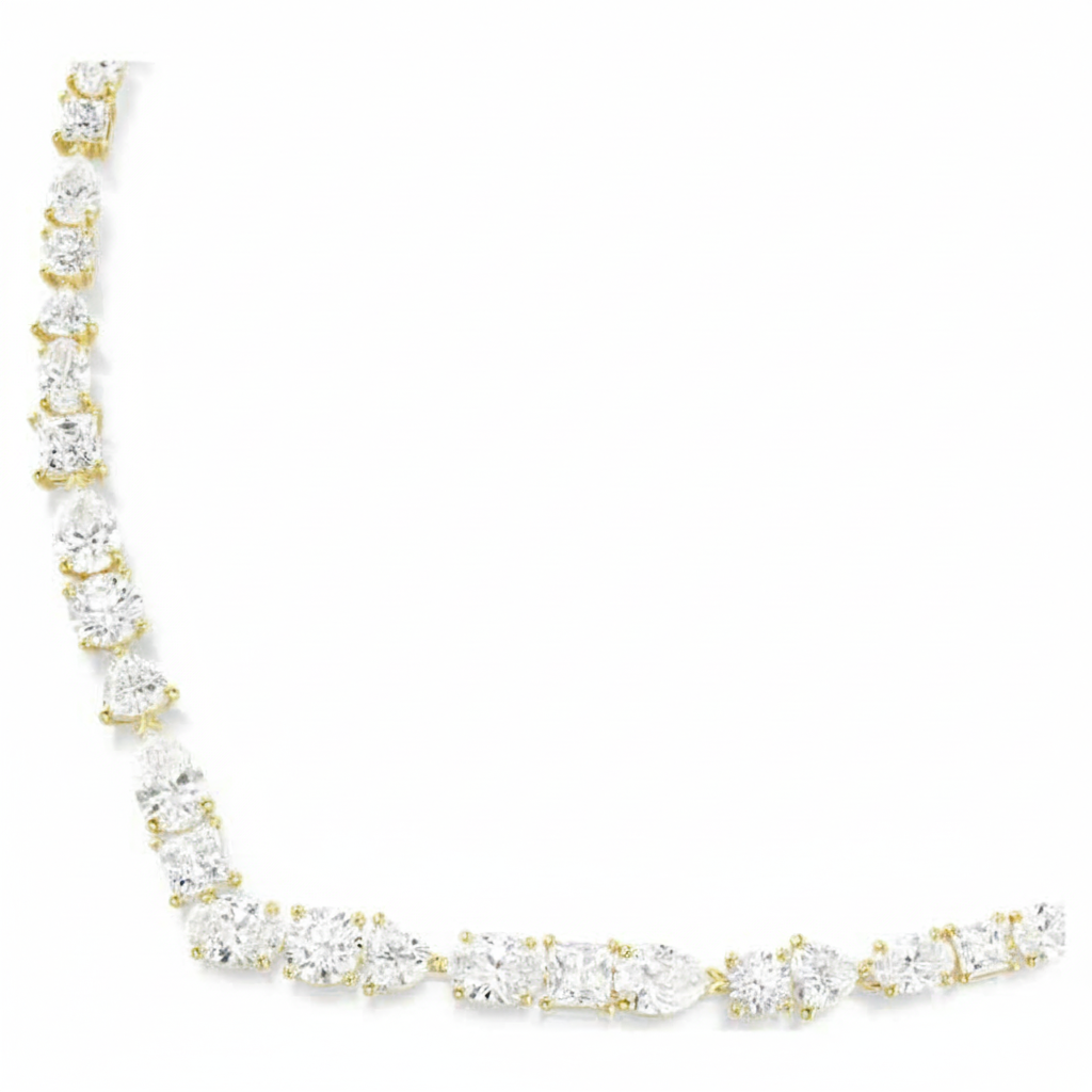 Swarovski Mesmera necklace with mixed cut white crystals and gold-tone plated chain, elegant jewelry accessory.