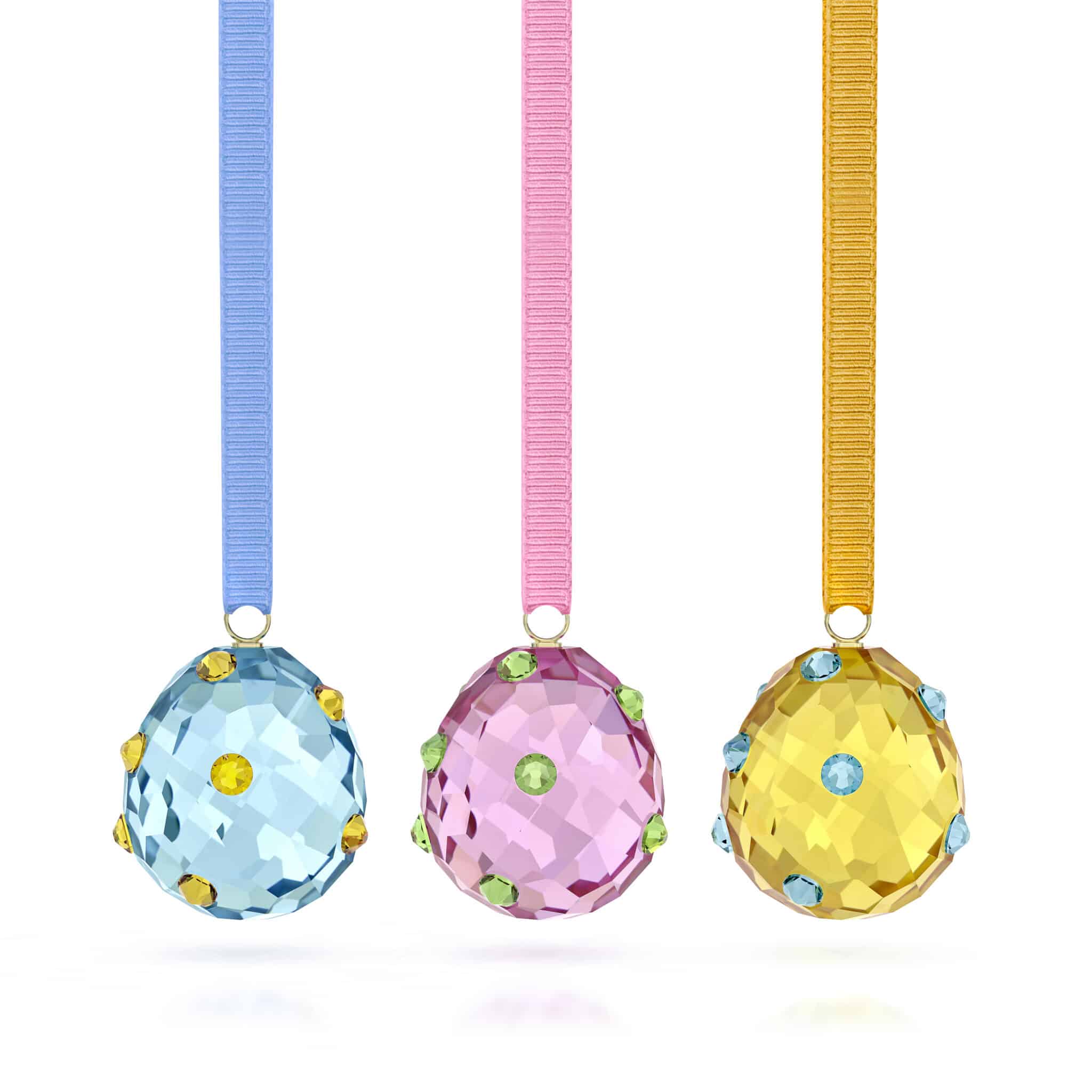 Swarovski Idyllia Eggs Ornament Set featuring intricately crafted crystal eggs with elegant designs on a white background.