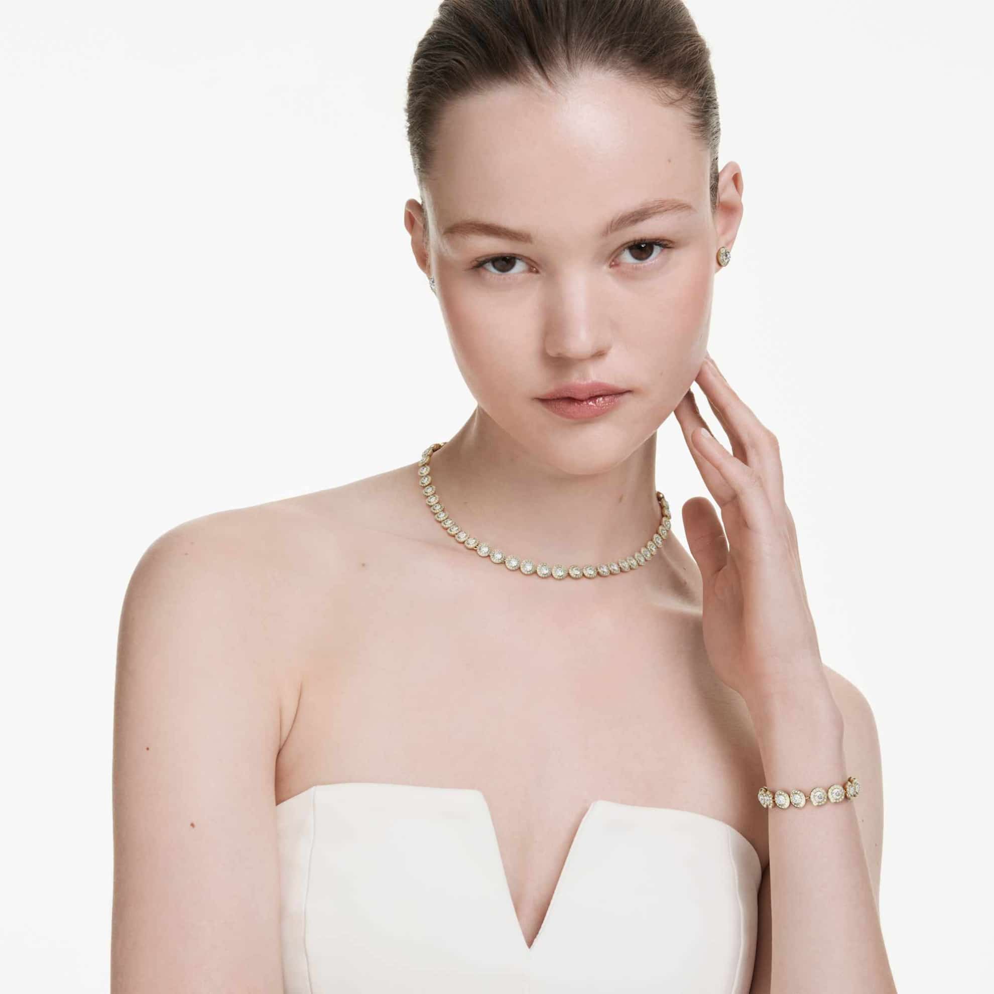 Swarovski Una Angelic set featuring three round-cut white crystals with gold-tone plated accents, elegant jewelry collection.
