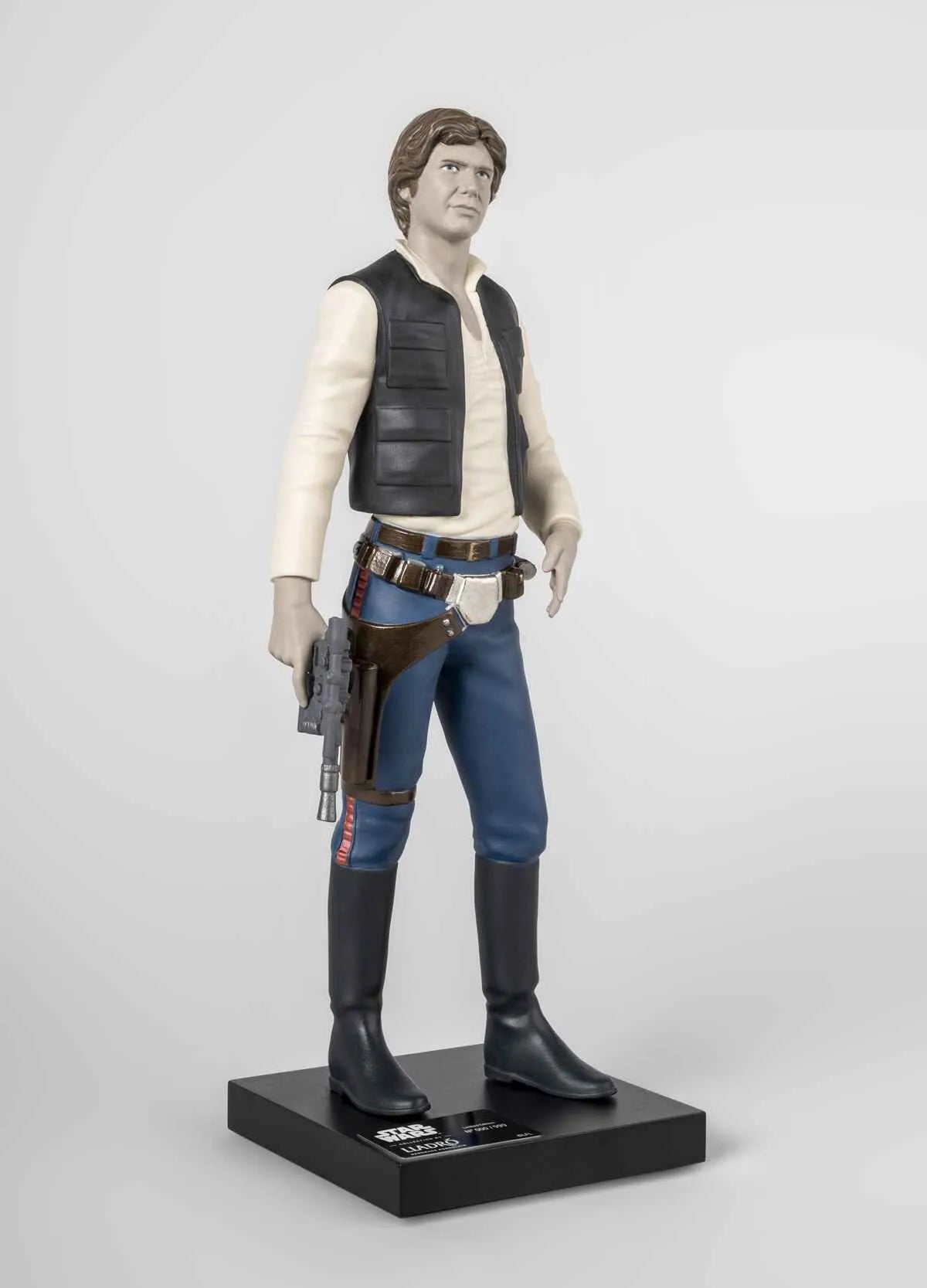 Lladro Han Solo™ sculpture in limited edition, detailed ceramic figure of Star Wars character on a plain background.