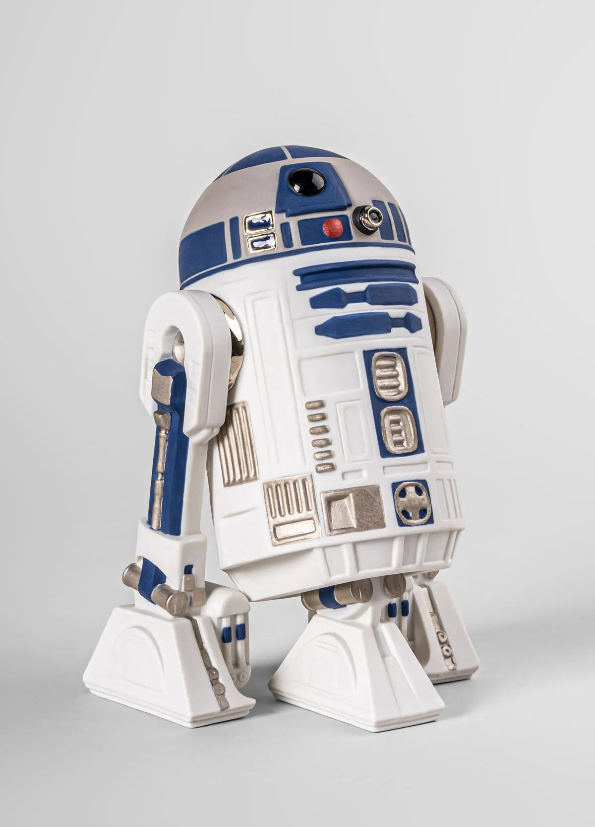Lladro R2D2™ sculpture showing a detailed ceramic replica of the iconic Star Wars droid with intricate blue and white design.