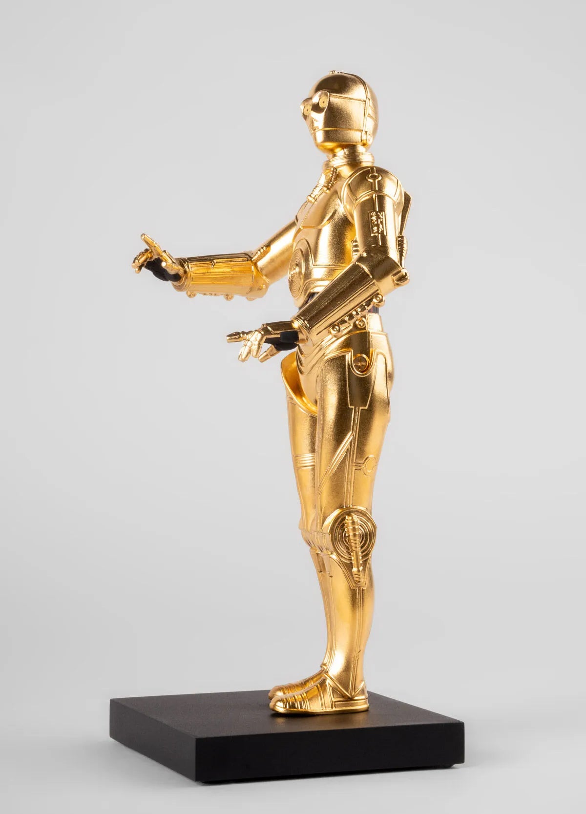 Lladro C3PO™ sculpture showing detailed, glossy gold finish and intricate craftsmanship of the iconic Star Wars character.