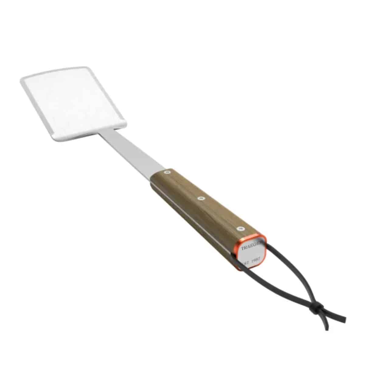 Traeger BBQ spatula with black handle and metal blade, ideal for grilling and flipping burgers or steaks during outdoor cooking.