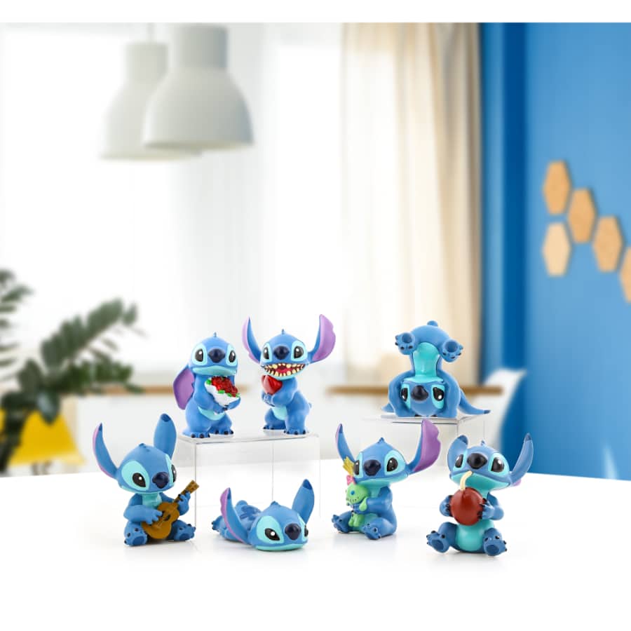 Disney Stitch plush toy holding a heart, featuring Stitch's signature blue fur and expressive eyes, perfect for Disney fans.