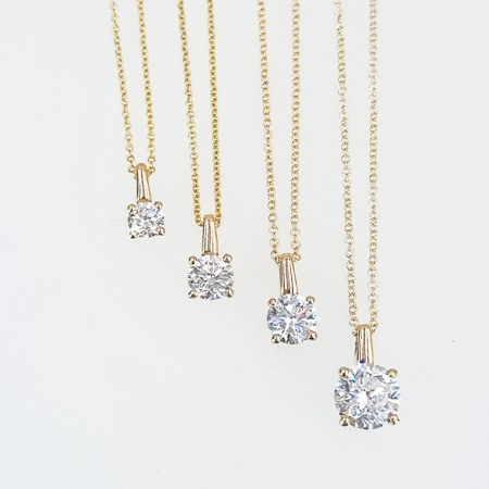 Lab Grown Diamonds 9CT yellow gold pendant with a sparkling diamond centerpiece, showcasing elegant jewelry craftsmanship.