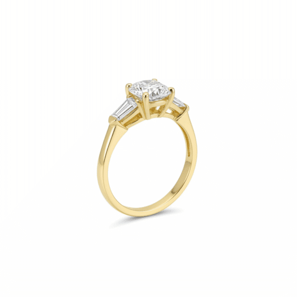 Lab Grown Diamonds 9CT yellow gold ring with a 1CT round and pear-shaped diamond design, elegant jewelry piece.