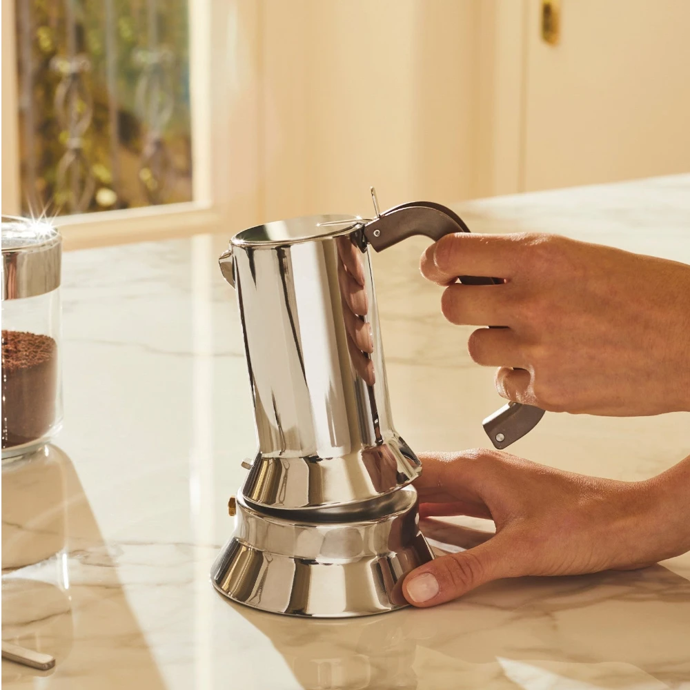 Alessi 9090 Perforated Handle Espresso Maker with stainless steel body and ergonomic handle, designed for brewing espresso.