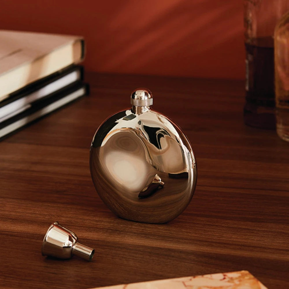 Alessi Shot Hip Flask with stainless steel finish, compact design, and screw-on cap for portable alcohol storage.