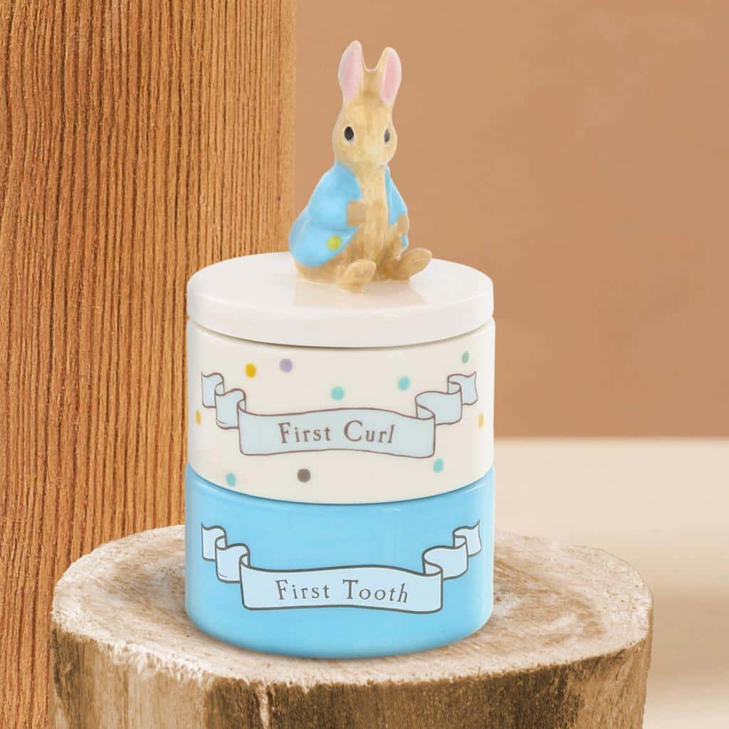 Beatrix Potter ceramic set featuring Peter Rabbit tooth and curl keepers with detailed illustrations and a charming design.