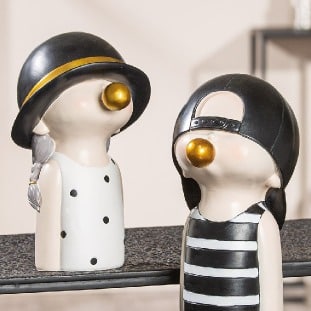 Gilde resin figurine of a boy chewing gum in black and white, 25cm tall, detailed and realistic sculpture.