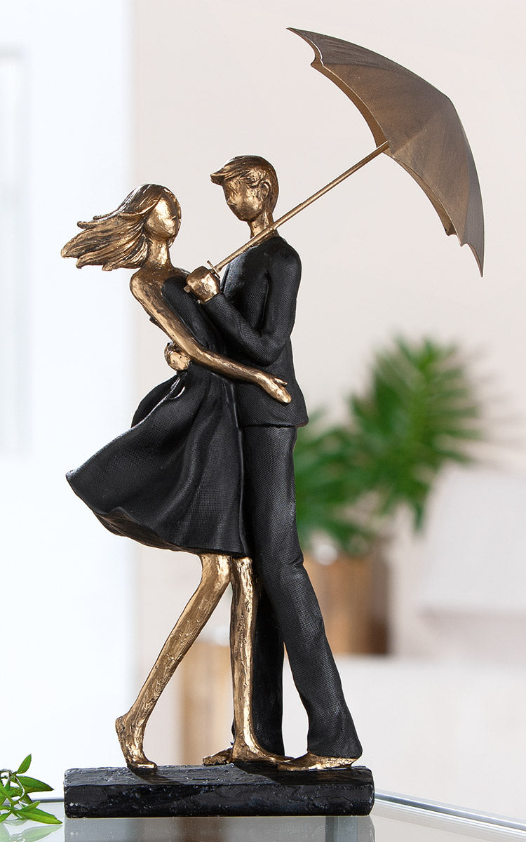 Pair of Gilde rain umbrella sculptures in black and gold with decorative umbrella designs, perfect for stylish home decor.