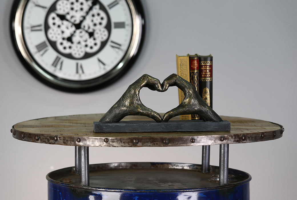Gilde bronze sculpture featuring a heart motif with hand design, showcasing detailed poly bronze craftsmanship.